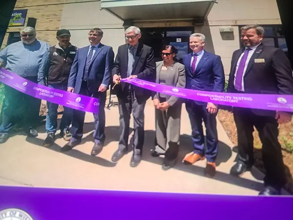 Governor Evers and group cutting ribbon